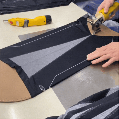 Worker cutting fabric for activewear leggings at Zi Yang factory, highlighting the precise cutting process in activewear production.